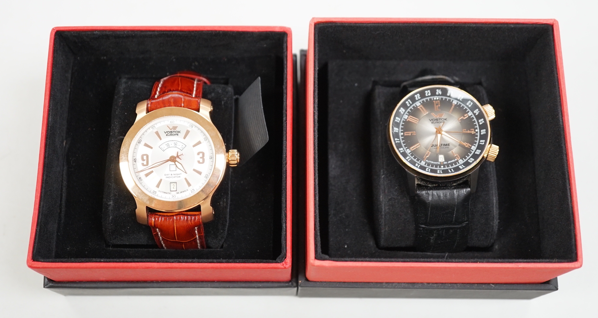 Two gentleman's modern gilt stainless steel Vostok Europe automatic wrist watches, including Dual Time and AN255 Mriya, in boxes.